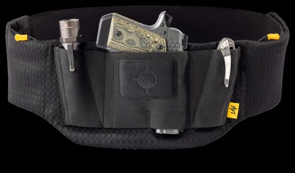 A Mission First Tactical belly band holster displayed against a plain background. The stretchy, one-size-fits-most holster is shown holding various accessories, including a handgun, knife, and flashlight (accessories not included).